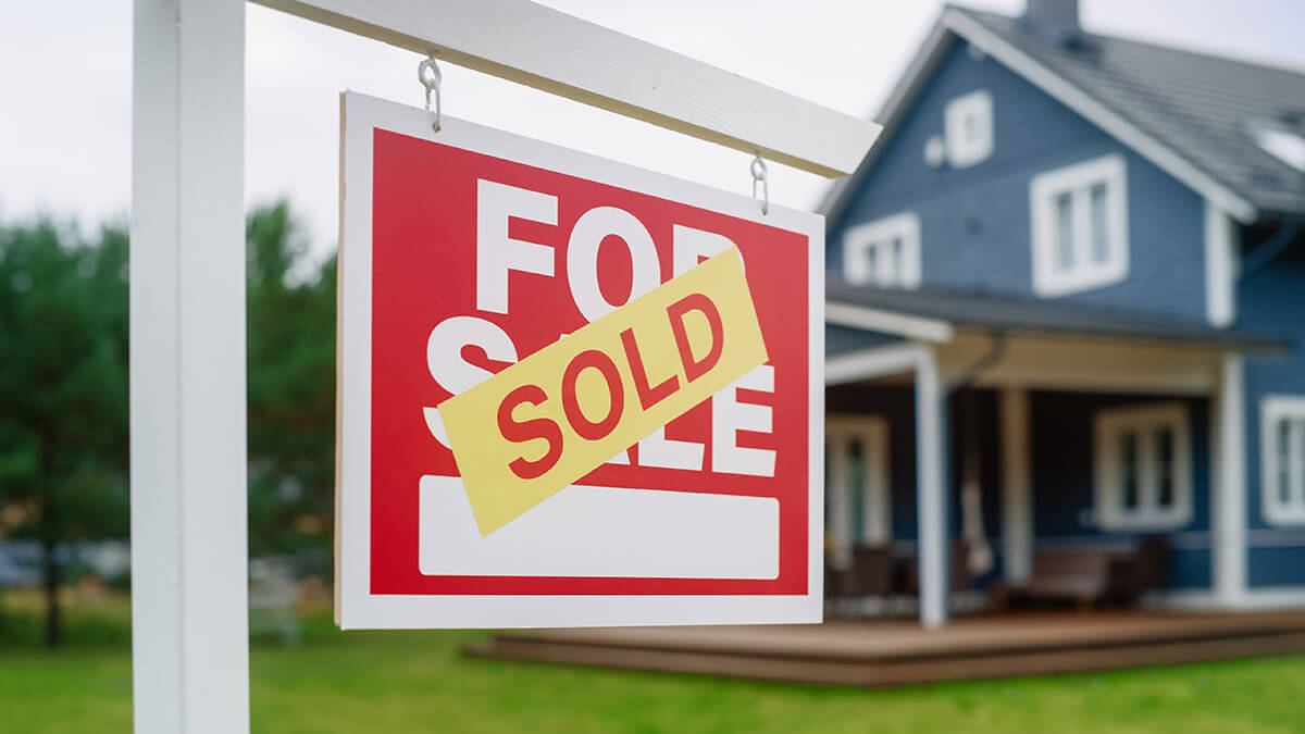 Close Up of a House Sold Sign on a Lawn
