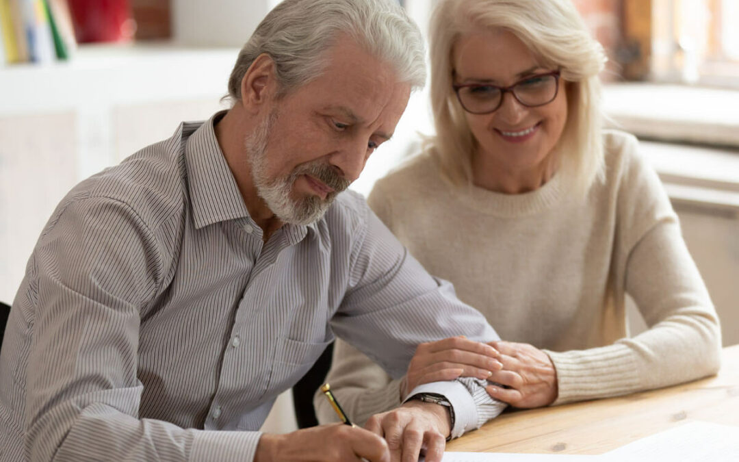 old couple sign legal paper